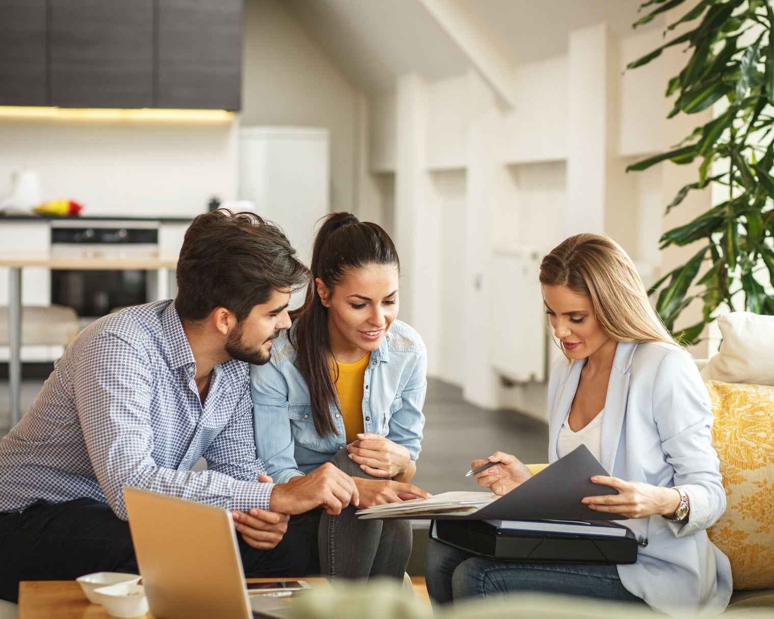 couple going over paperwork with a woman