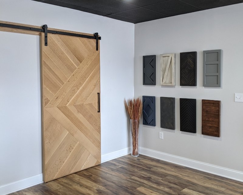walston door's showroom, with a single panel door installed on a wall next to wood samples